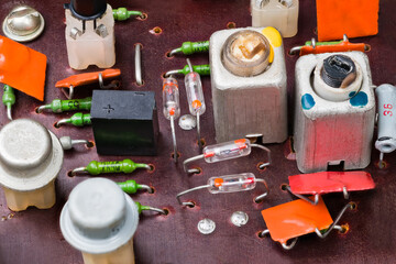 Obsolete electronic components on a circuit board of old radio. Retro germanium transistors and...