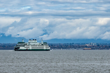 Washington State Ferry Travels Towards Mukilteo On a Cloudy Day With Everett Washington in...