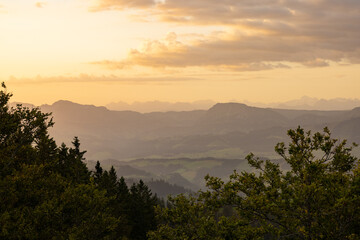 Amazing sunset at a wonderful landscape in Switzerland on a hill called Napf. Wonderful morning view with the alps in the horizon.