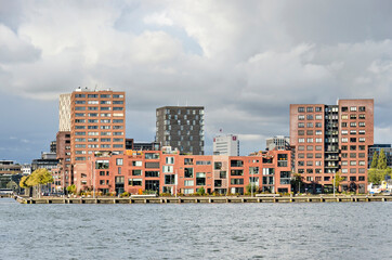 Rotterdam, The Netherlands, November 4, 2021: former industrial zone on Mullerpier converted to residential neighbourhood with low and medium high brick buildings - obrazy, fototapety, plakaty