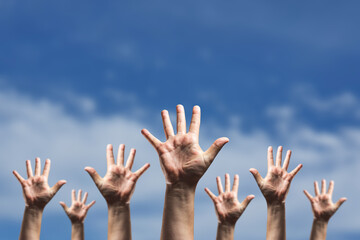 Raising hands against blurred cloudy sky , donation and volunteers work concept