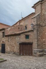 Fototapeta na wymiar typical street of Medinaceli with stone houses and a wooden door and a lantern
