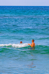 people swim at beach landscape panorama Can Picafort Mallorca Spain.