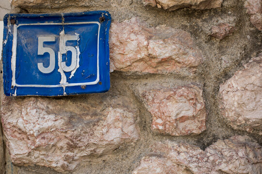 Number 55 plaque on a house wall