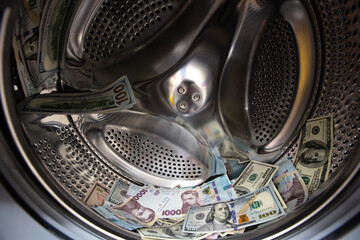 dollar and Ukrainian hryvnia banknotes in washing machine
