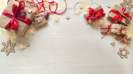 Christmas background with holiday gifts in craft paper with red ribbon wood winter elements.