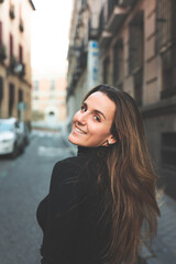 Young caucasian woman walking through the streets of Madrid, Spain.