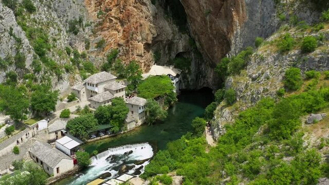 Aerial: Time Lapse Shot Of Tourists At Famous Vrelo Bune, Drone Descending Over River - Blagaj, Bosnia and Herzegovina