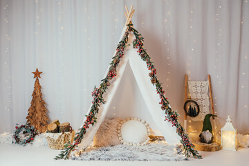 Christmas backdrop with lights and teepee tent illuminated in the dark. 
