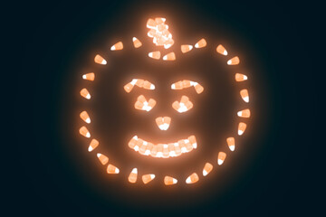 Glowing graphic of candy corn arranged in the shape of a carved halloween pumpkin isolated on a black background