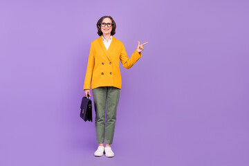 Full body photo of happy positive old woman point finger empty space suitcase business isolated on...