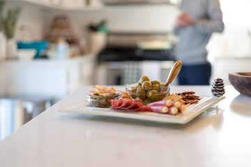 Soft focus charcuterie board on a white platter