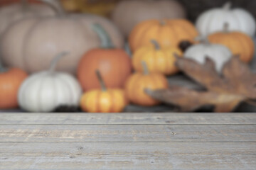 Empty wooden table mockup in front of blurred fall, thanksgiving, Halloween pumpkin background.