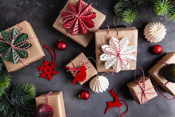 Christmas gift boxes decorated with red, green, white snowflakes made of paper.