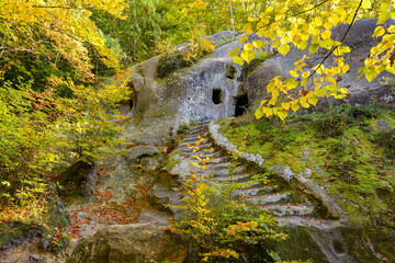 Cave Monastery in Rozhirche, Lviv Oblast, Ukraine. Ancient rocky temple in the forest, in the Carpathian mountains.