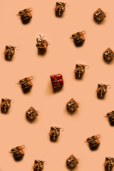 Many small identical gifts on a pale pink background. Present pattern. Isolation. High quality photo
