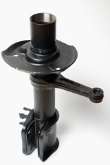 Car spare parts. Car front shock absorber. Contrasting photo on a white background. Front strut hydraulic shock absorber