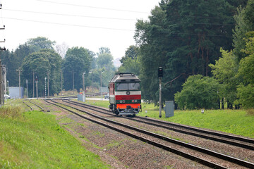 diesel locomotive approaches a railway crossing