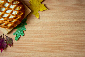 Baking, autumn leaves on a wooden background. Layout top view.