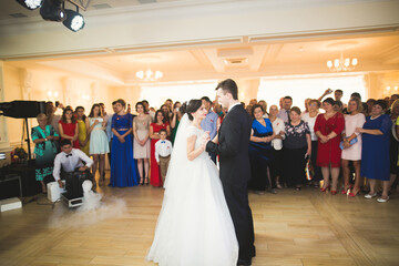 Beautiful caucasian wedding couple just married and dancing their first dance