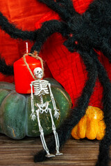 Halloween Attributes. Red candle, spider, pumpkin and skeleton.