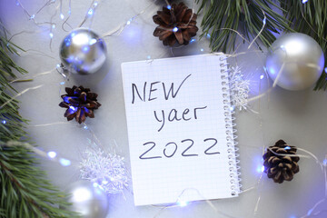 new year notepad with plans, bumps, light bulbs, garlands, balls