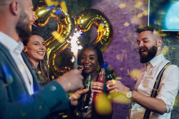 Fototapeta na wymiar Happy group of friends celebrate New Year's Eve in a club