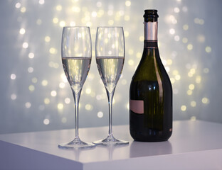 Two glasses of champagne against blurred lights