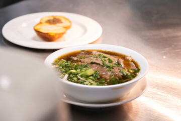 Delicious bowl of pho tai, rich broth, Vietnamese dish, soup, rice noodles.
