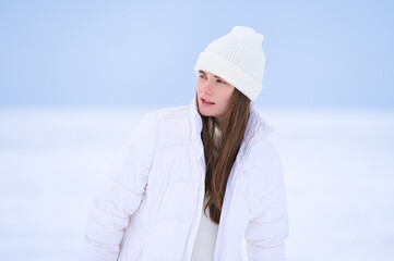 Closeup of happy women  in hat and sweateron snow outdoor