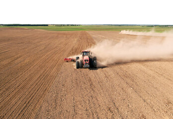 Obraz premium Tractor with Plough on Plowed. Ploughing and Soil Tillage. Agricultural Tractor on Cultivation Field for Sowing Seeds. Tractor During Field Cultivating. Planting and Seeding Equipment.