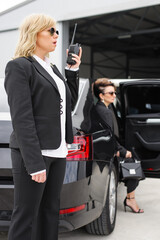 Female Bodyguard with walkie talkie. Celebrity and VIP person security