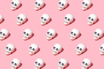 pattern from human skulls. Trending image on a pink background for the holiday Halloween