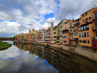 Colorful historical houses,facades, reflected in water of the river Onyar, in Girona, Catalonia, Spain.
