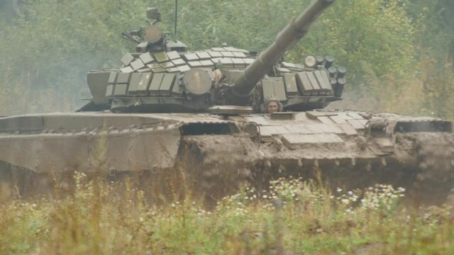 Barrel of the Tank Looks out of the Field
