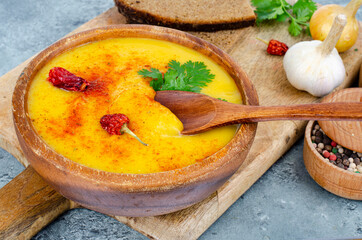 Spicy pumpkin puree soup with curry and saffron. Studio Photo.