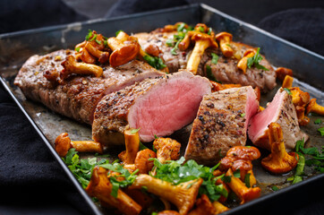 Fried dry aged pork fillet chateaubriand medallion steak natural with chanterelles and parsley...