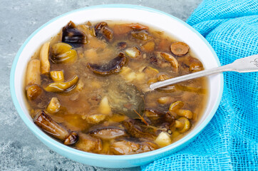 Delicious hot soup with wild mushrooms. Studio Photo.
