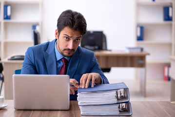 Young male employee working in the office