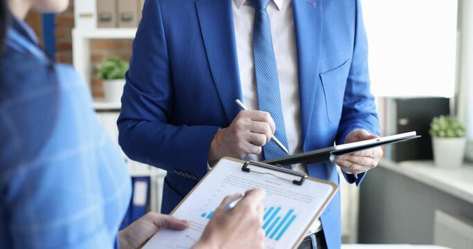 Business man and woman studying information on digital tablet and paper closeup 4k movie slow motion
