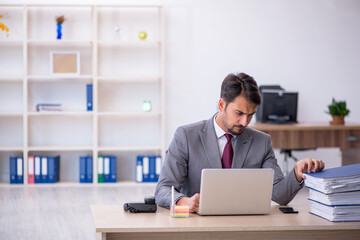 Young male employee working in the office