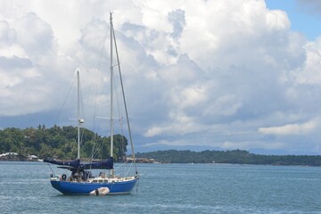 Fototapeta premium Sorong, West Papua, Indonesia, September 16th 2021. A beautiful little yacht is mooring at the sea. Raja Ampat tourism purpose.