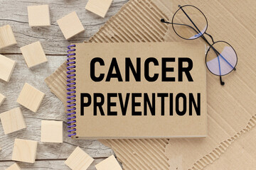 Cancer prevention. Workspace with glasses, notepad on a wooden table. Business concept. craft notebook pages.