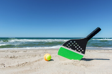 Racket and ball on the sandy beach. Horizontal sport poster, greeting cards, headers, website