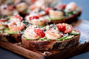 Open sandwich shrimp, avocado, tomatoes. Homemade smorrebrod with rye bread