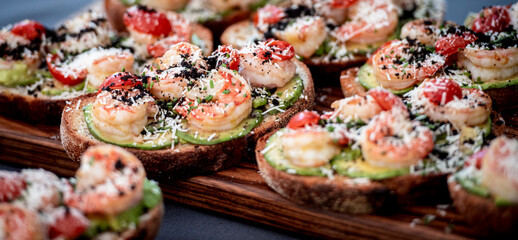 Open sandwich shrimp, avocado, tomatoes. Homemade smorrebrod with rye bread