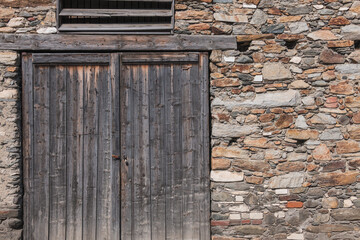 Facade of natural stones masonry and door