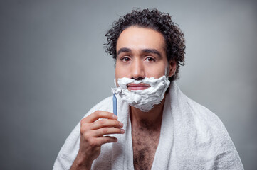 man shaving his face