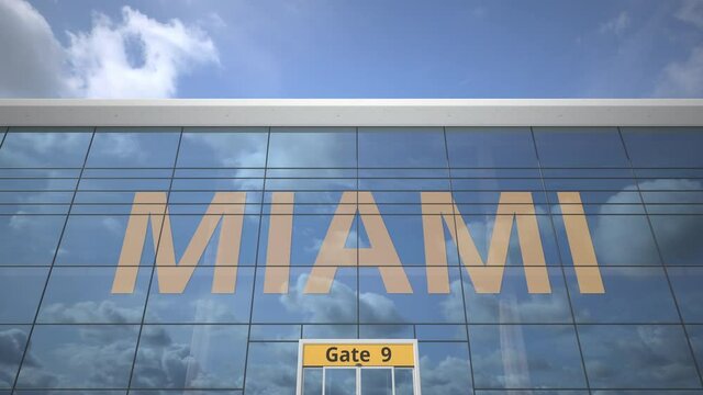 MIAMI text revealed with landing airplane on airport building