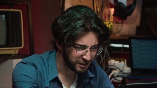 Gamer playing on laptop. Young angry man failed game. Professional gambling programmer infecting system with cyber virus, typing on computer keyboard, trying to break password. 